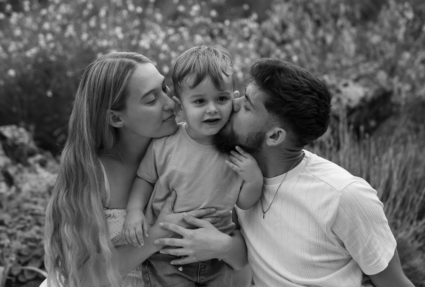 family portraits with their son in the middle