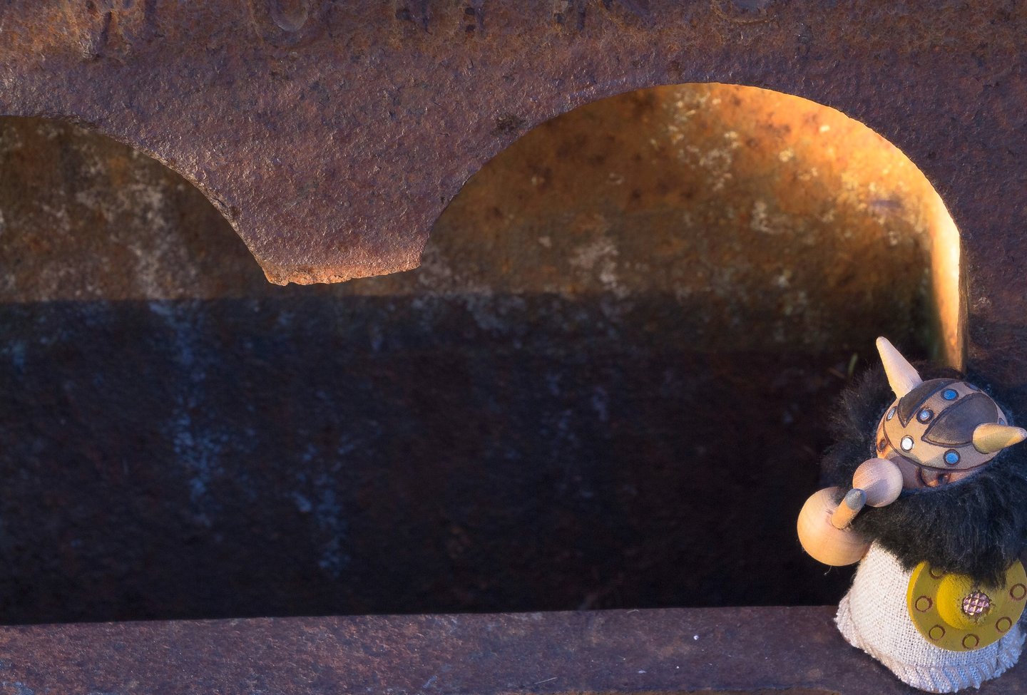 Night scene with an imaginary archway and a wooden Viking warrior toy.