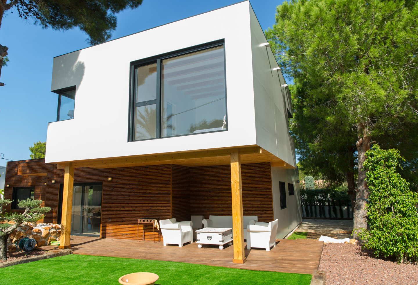 a house with a deck and a deck with chairs