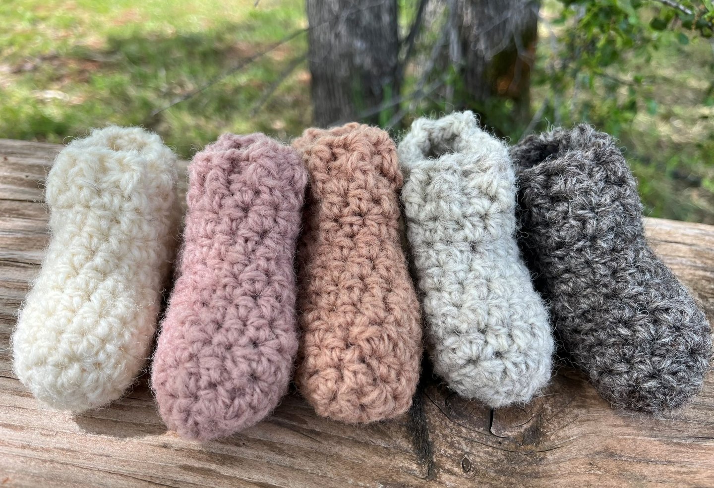 a group of knitted slippers with a variety of different colors