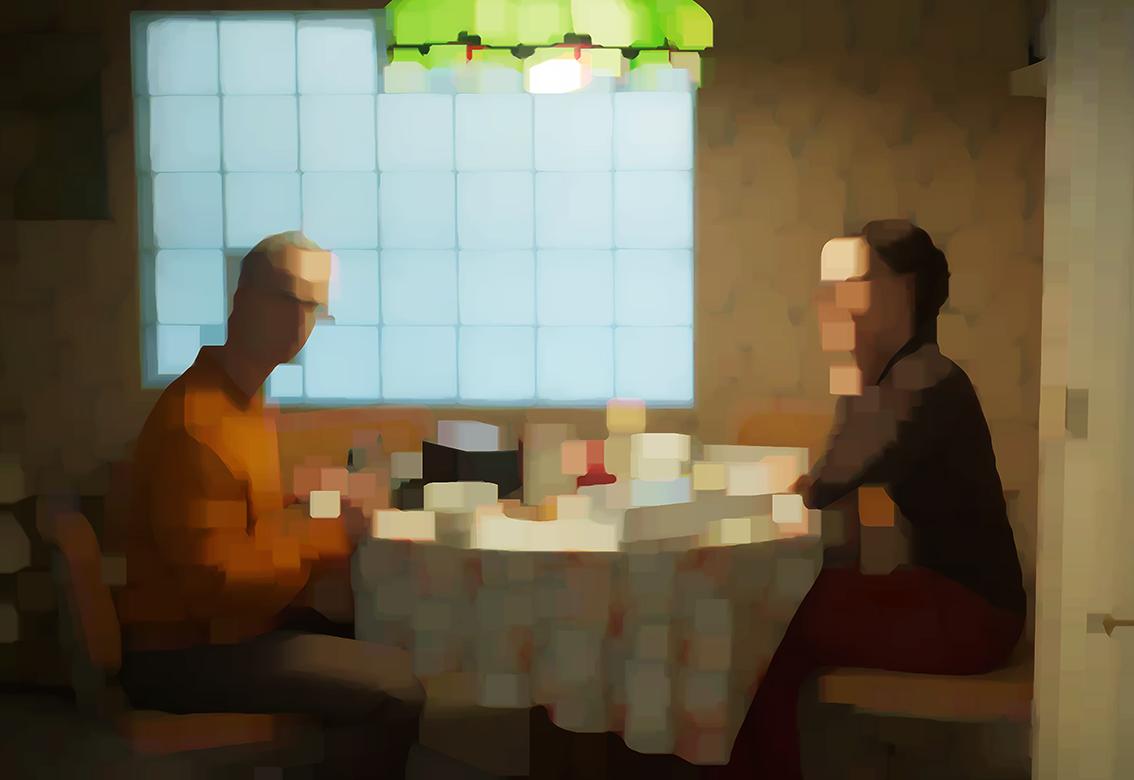 two people sitting at a table with a table cloth