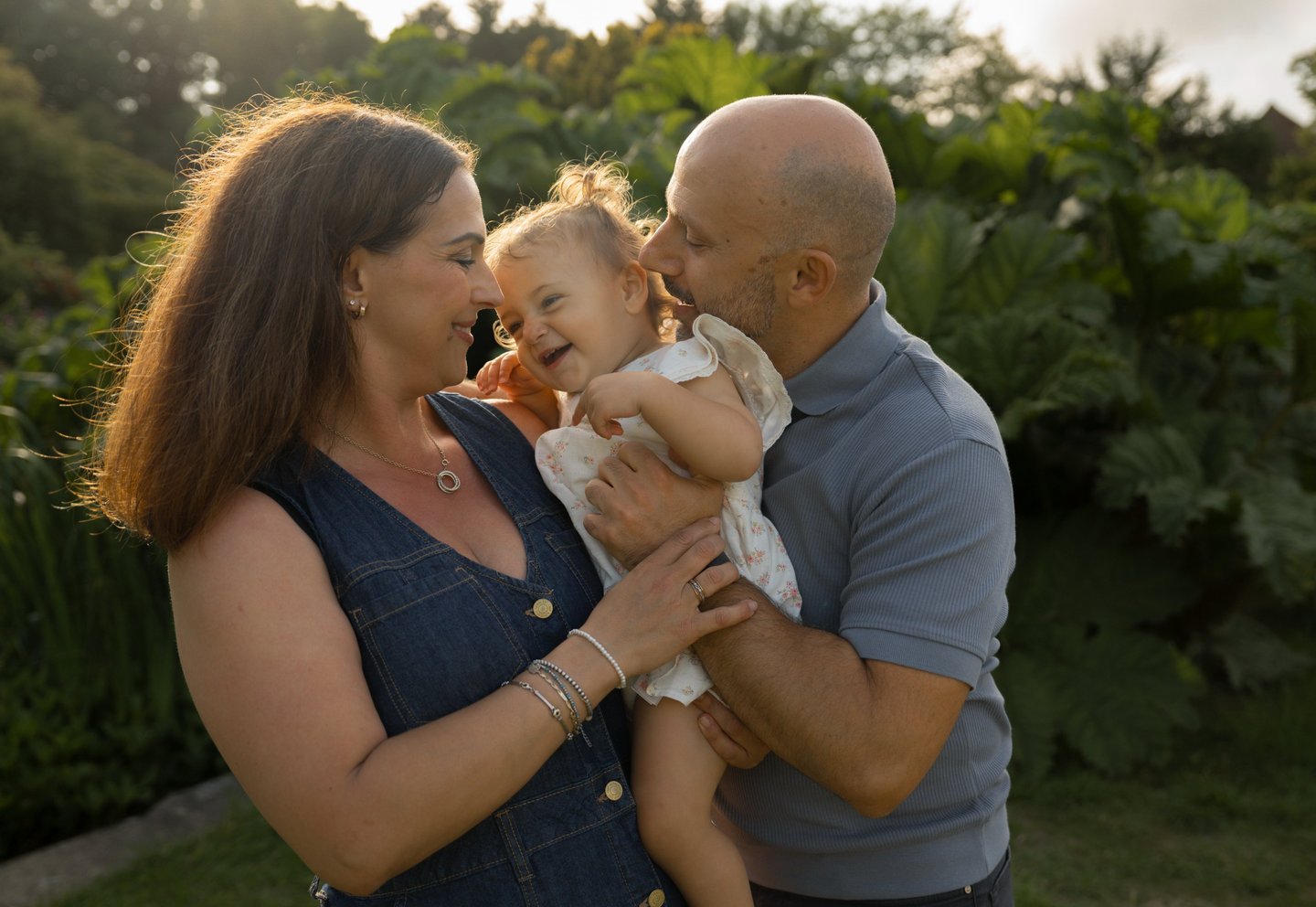 Family photo holding baby girl and laughing