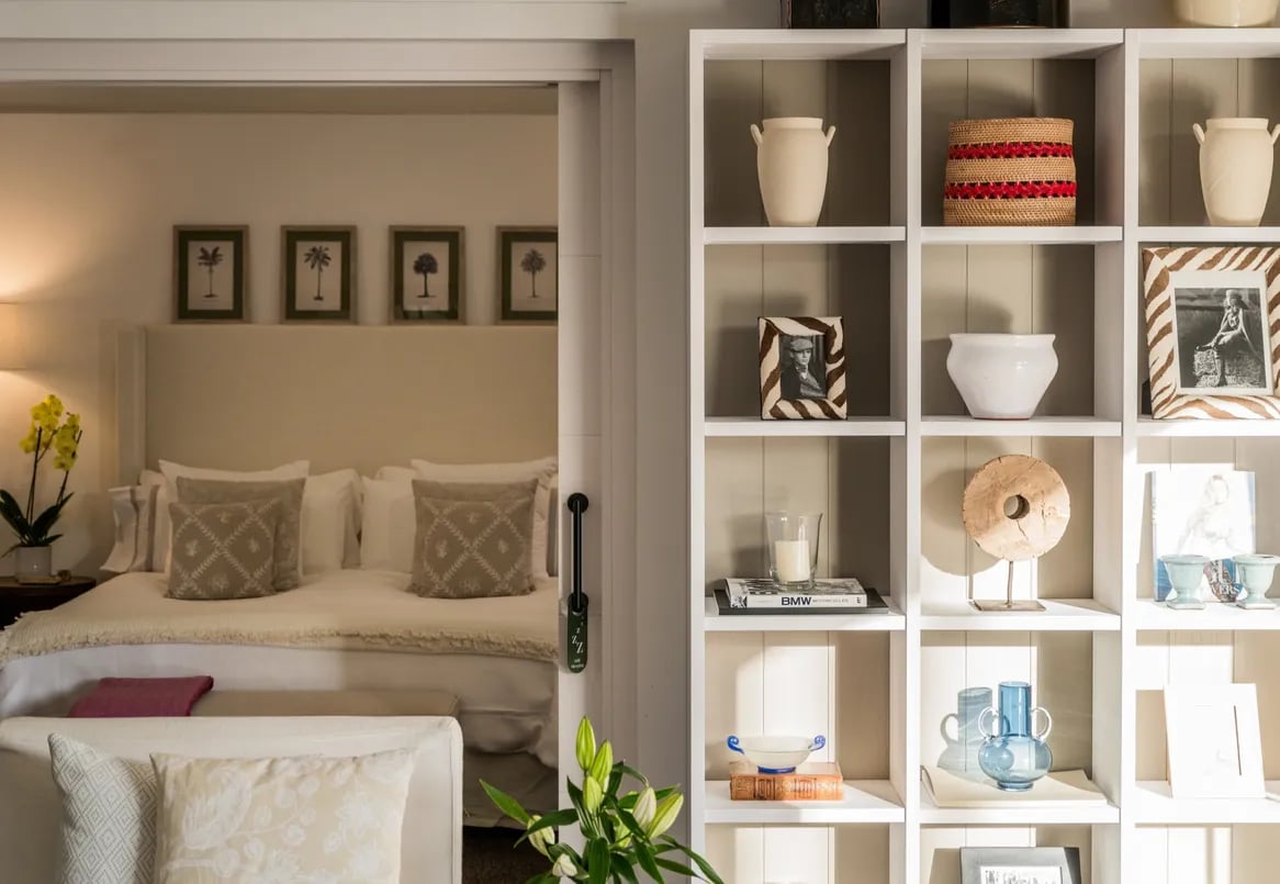 guest suite with soft neutral tones and decorative shelving at Villa El Olivo, Marbella