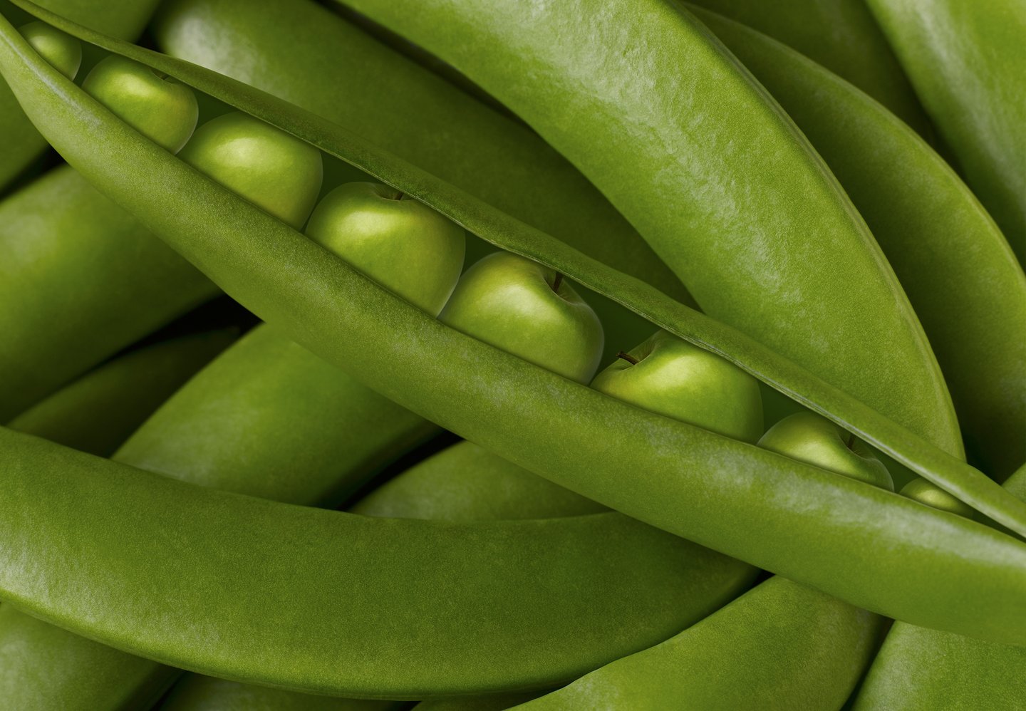green pea pods with tiny green apples inside