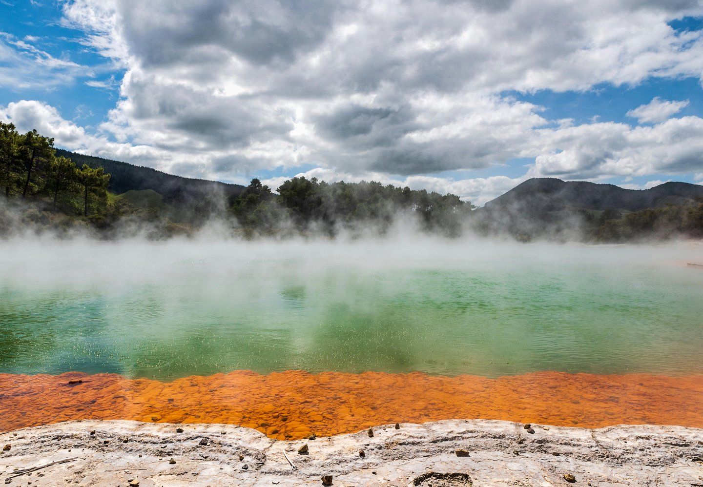 Steam rises from the colorful Champagne Pool at Wai-O-Tapu Thermal Wonderland in New Zealand.