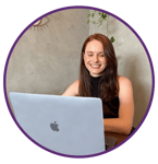 a woman sitting at a table with a laptop computer