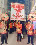 An old photo showcasing the Manohar Brass Band during a roadshow for Gangaur festival.