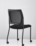 V137 black mesh-back chair, side angle with visible frame and castors