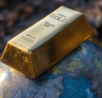 gold bar on a globe symbolizing the importance