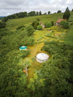 a farm with a round shaped structure and a round shaped structure