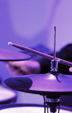 Purple lighting with up close drums