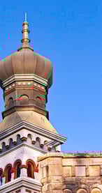 Historic Georgetown, Texas building featuring iconic onion dome architecture under a bright blue sky.