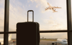 a suitcase and a suitcase in front of a window