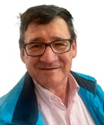 realportrait a man in a blue jacket and glasses