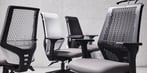 Row of T145 clerical chairs with perforated plastic backs in black and white finish