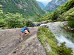 Kids climbing barefoot after crossing a stream,