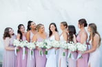 A moment captured by Los Cabos Wedding Films at the Garza Blanca Hotel in San José del Cabo: Bride admired by bridesmaids hol