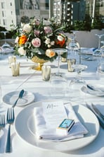 A captured moment of an elegant table setting with decorated plates and cutlery at the wedding in Los Cabos. Captured by our