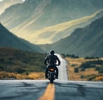 a man riding a motorcycle down a road