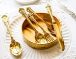 premium golden crockery on white plate provided by royal crockery and counters