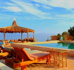 Bedouin star pool with lounge chairs and umbrellas