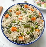 Vegetable Pulao, a fragrant, one-pot rice dish cooked with a medley of fresh vegetables & spices.