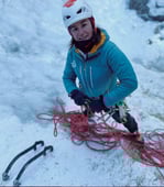a woman in a helmet on a mountain in a ski and sail in norway