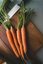 carrots and a knife on a wooden board