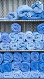 All blue towels rolled neatly