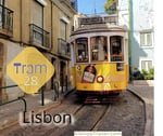 Cute looking yellow tram waiting on a stop in Lisbon & a sign that says 'Tram 28'
