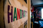 a poster with the inscription “HANDRATTY” in a room