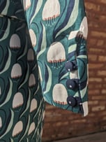 Covered buttons of a green art nouveau 50's inspired cropped jacket