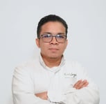 a man in a white shirt and glasses