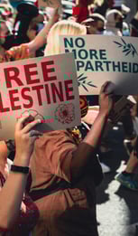 a group of people holding signs that read free palestine