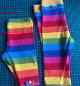 a pair of leggings with a rainbow - colored striped leggings