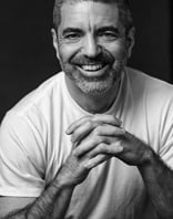 a man with a beard and a white shirt