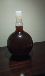 a bottle of liquid in a glass bottle