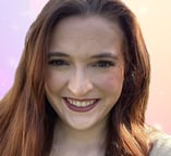 a woman with long hair and a smile on her face