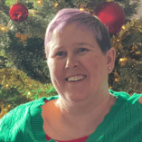 Woman With Green Shirt Christmas Tree Behind Her