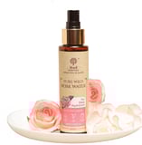 a bottle of pure water with pink roses on a plate