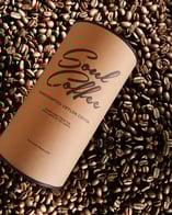 a coffee composite cup sitting on top of a pile of coffee beans