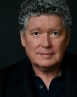 a man with a gray hair and a black shirt