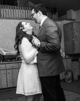 a bride and groom dancing while looking at one another