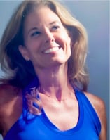 a woman in a blue tank top and a white shirt