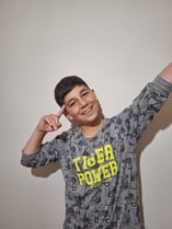 a young boy with a gray shirt and a black shirt
