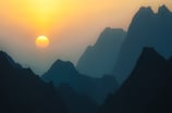 a sunset over a mountain range with a bird flying by. arbab naimat kasi, Quetta, balochistan