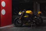 a yellow motorcycle parked in a parking lot