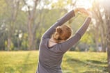 a woman stretching her arms in the air