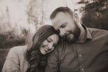 Father and teenage daughter share a tender moment as she rests her head on his shoulder during a Dul