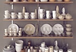 Premium kitchenware and crockery displayed on wall racks by art of kitchen